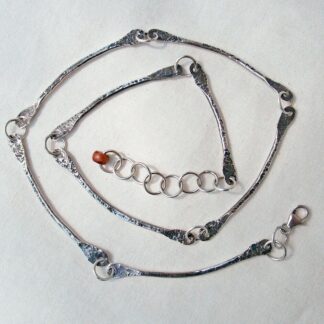 Handmade sterling silver necklace with nine flat textured dangles